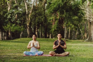 Partners meditating in Nature
